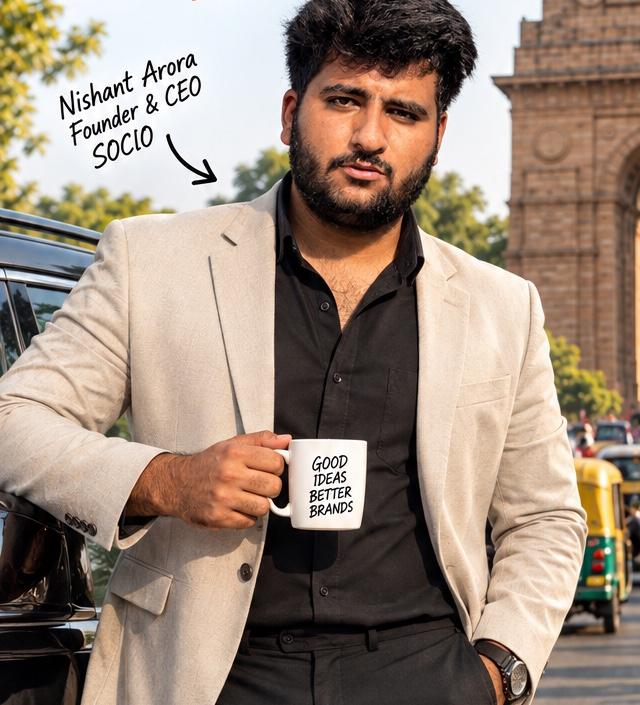 Nishant Arora, Founder & CEO of SOCIO, holding a "Good ideas, better brands" mug near India Gate, New Delhi